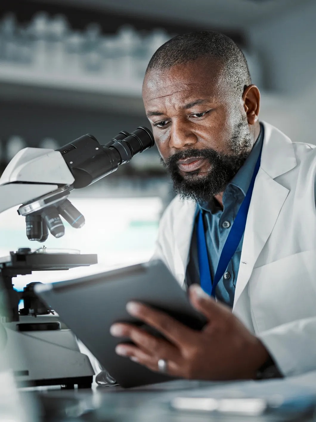 Medical researcher reviewing lab findings on a tablet