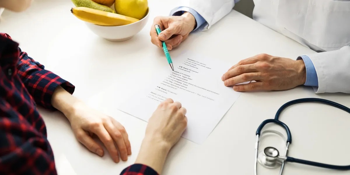 Doctor reviewing consultation paperwork with a patient